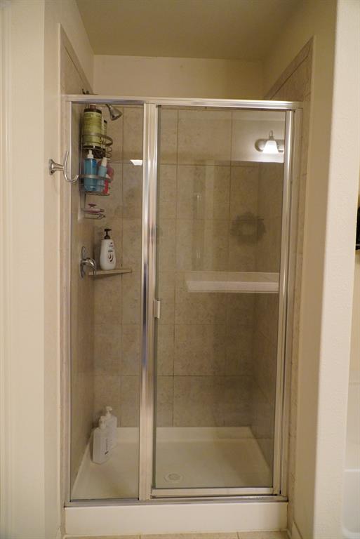 13624 Helix Bridge Way Crowley, TX 76036 - Photo 20 of 25 a bathroom with a glass shower door