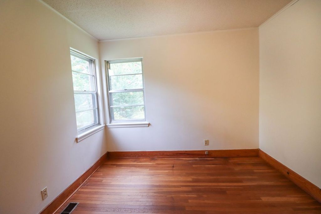 533 Best Street Ripley, TN 38063 - Photo 14 of 27 an empty room with wooden floor and windows