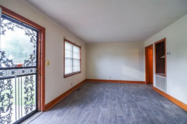 a living room with furniture a large window and a flat screen tv