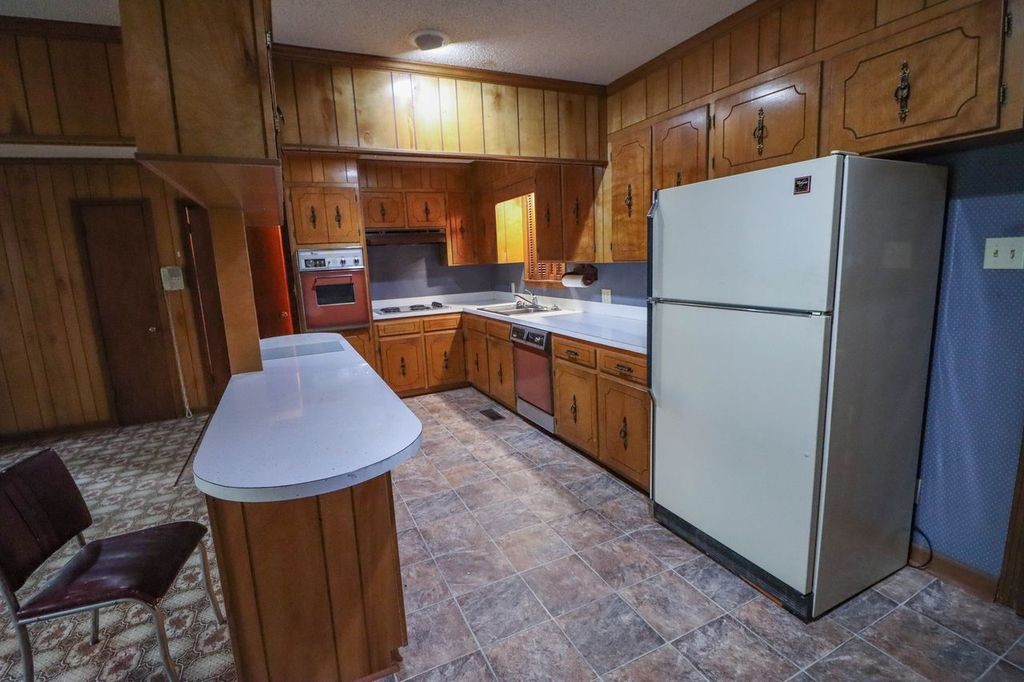 533 Best Street Ripley, TN 38063 - Photo 22 of 27 a kitchen with stainless steel appliances granite countertop a refrigerator a sink and a stove