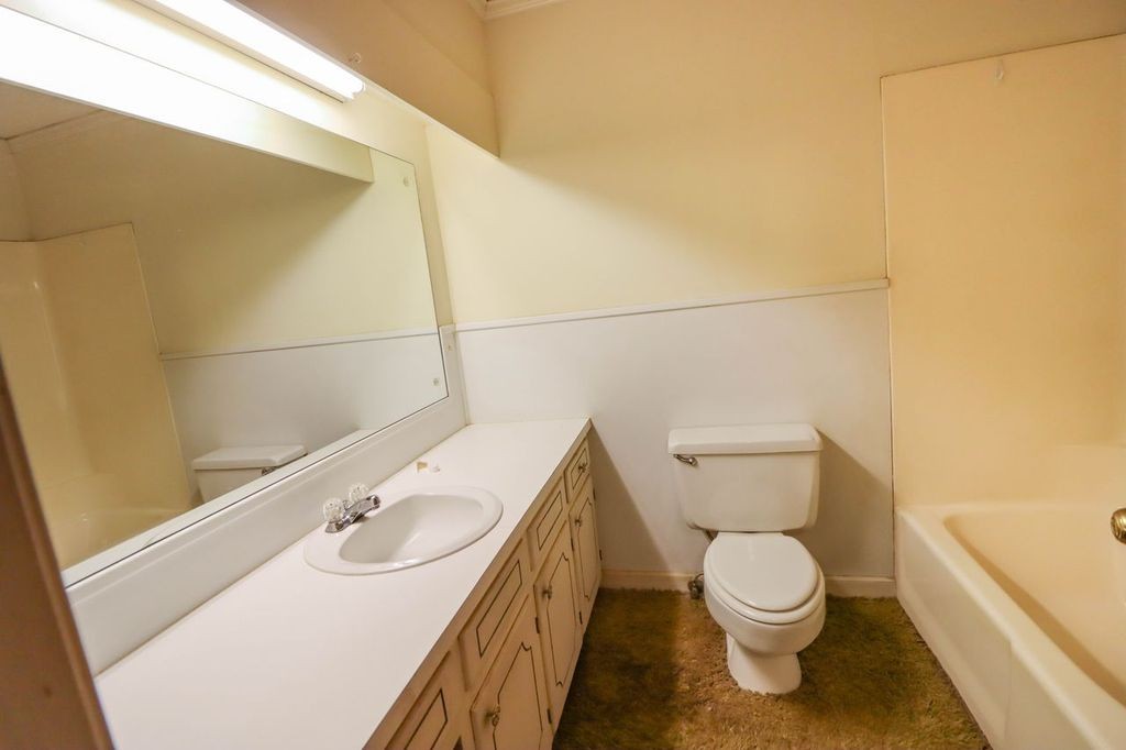 533 Best Street Ripley, TN 38063 - Photo 25 of 27 a bathroom with a sink a toilet and mirror