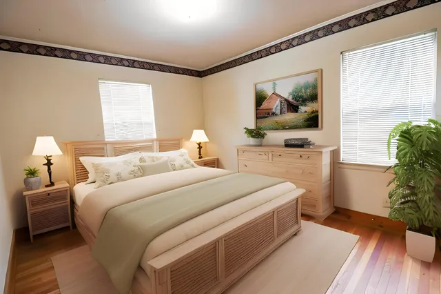 a bedroom with a bed and a potted plant