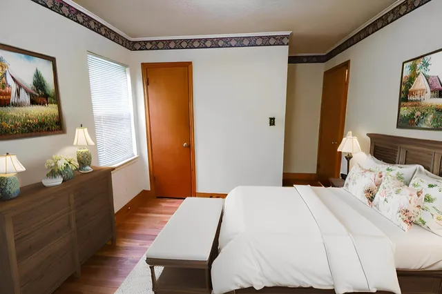 a bedroom with a bed and a dresser in it