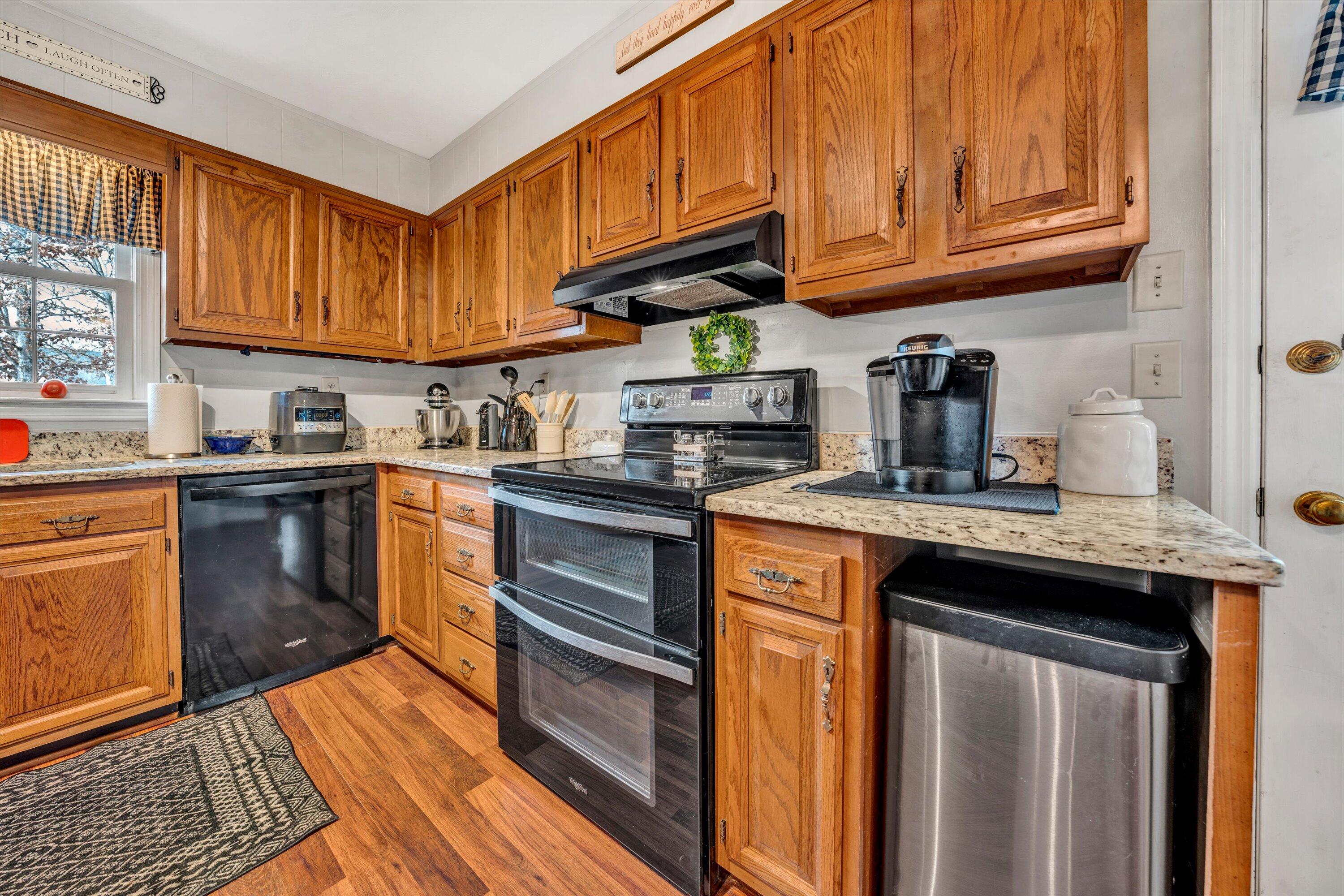 87 Queen Regent Court Blue Ridge, VA 24064 - Photo 13 of 38 a kitchen with stainless steel appliances granite countertop a sink a stove and cabinets