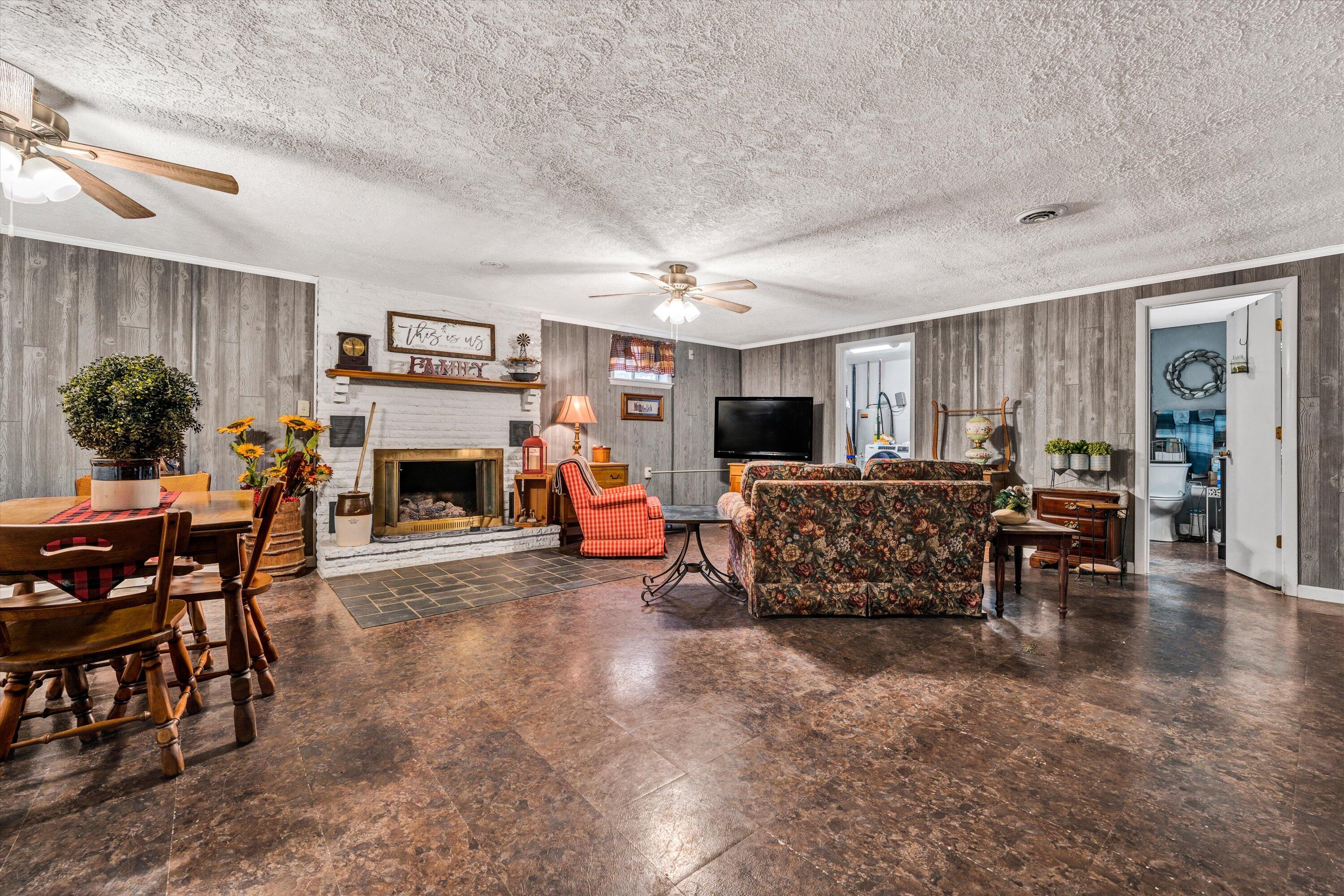 87 Queen Regent Court Blue Ridge, VA 24064 - Photo 27 of 38 a living room with furniture a fireplace and potted plants