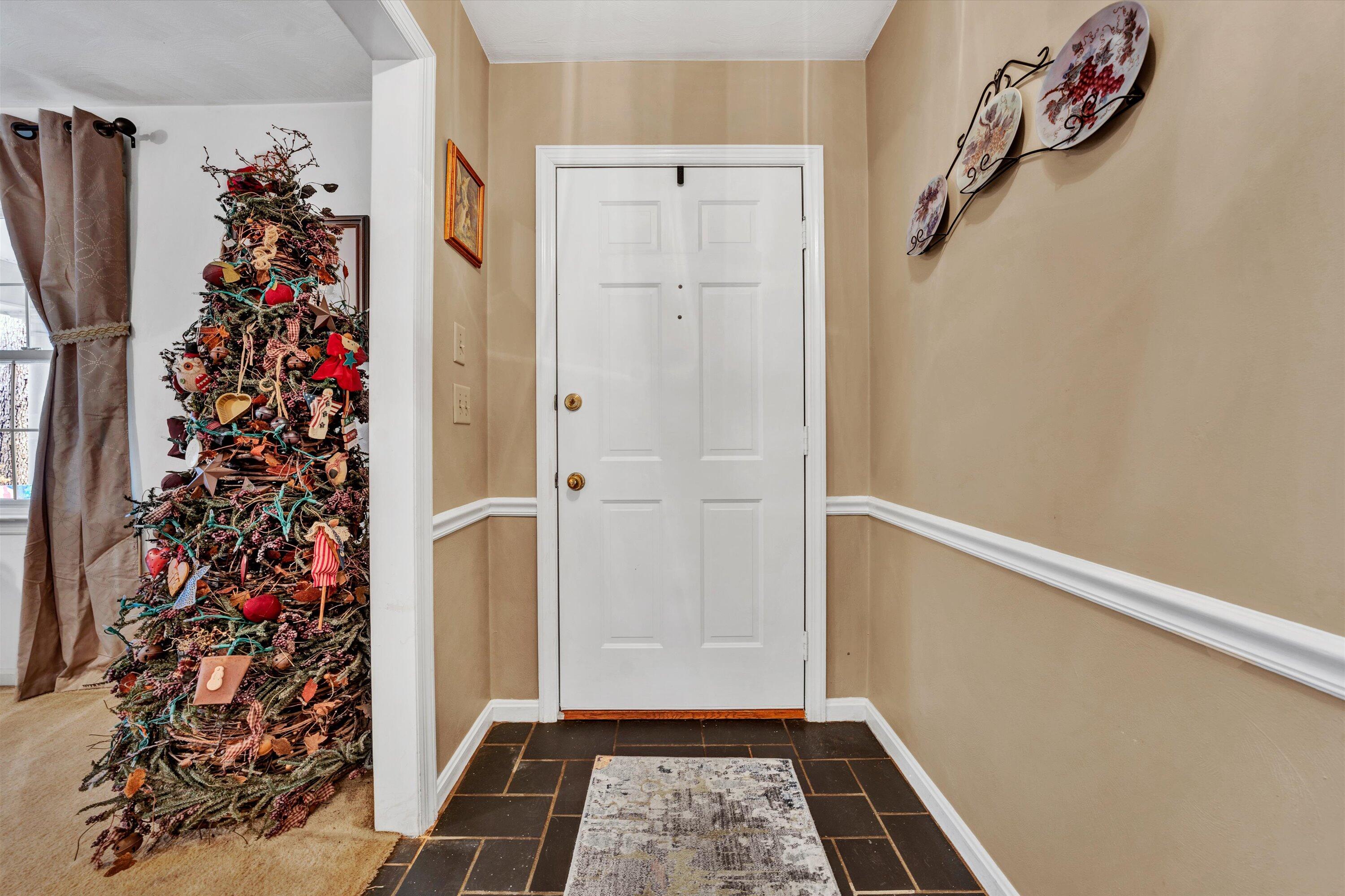 87 Queen Regent Court Blue Ridge, VA 24064 - Photo 6 of 38 a view of a hallway with flower plants and wooden floor