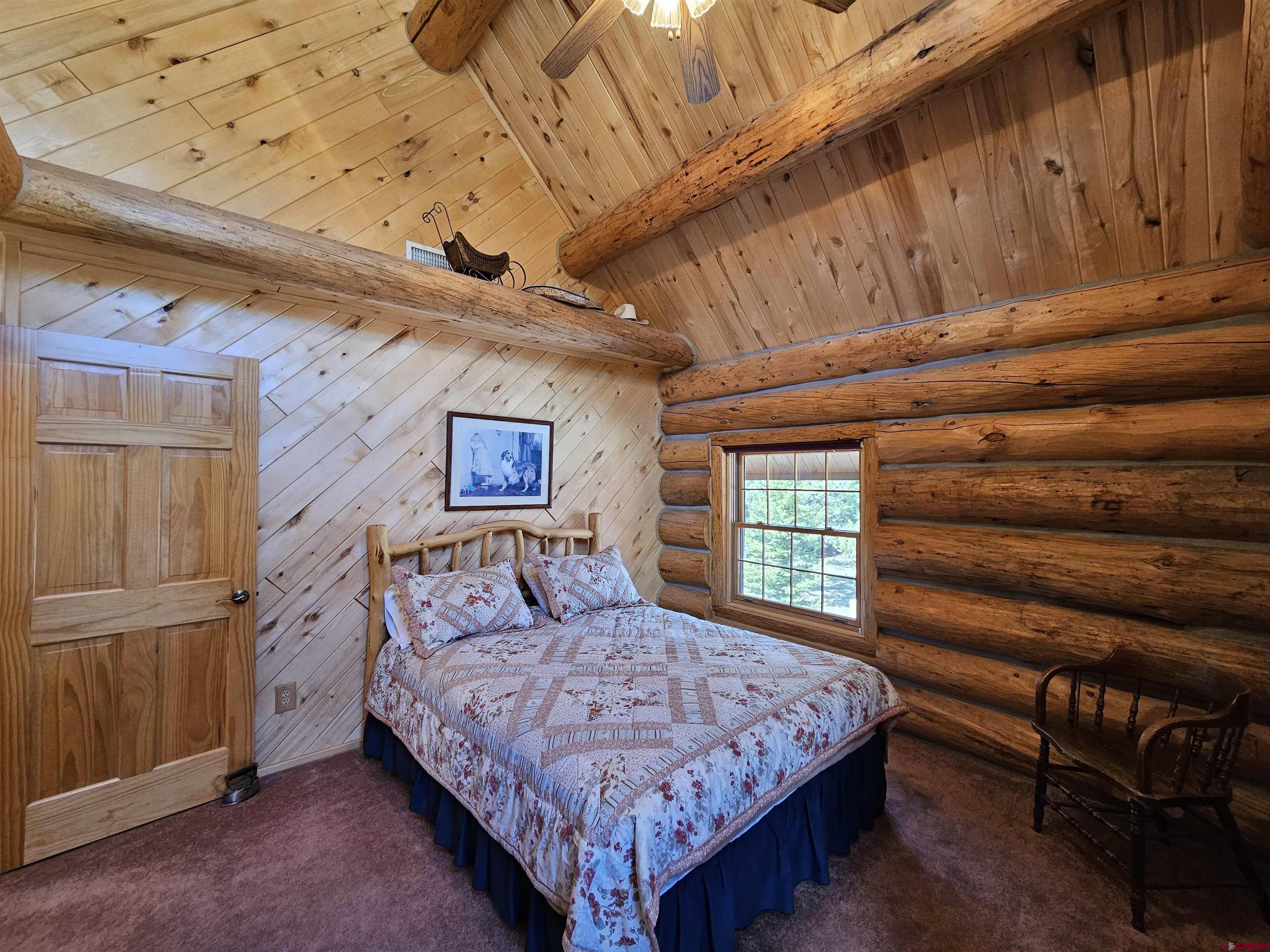 212 Pleasant Drive Ridgway, CO 81432 - Photo 20 of 35 a bedroom with a bed and a window