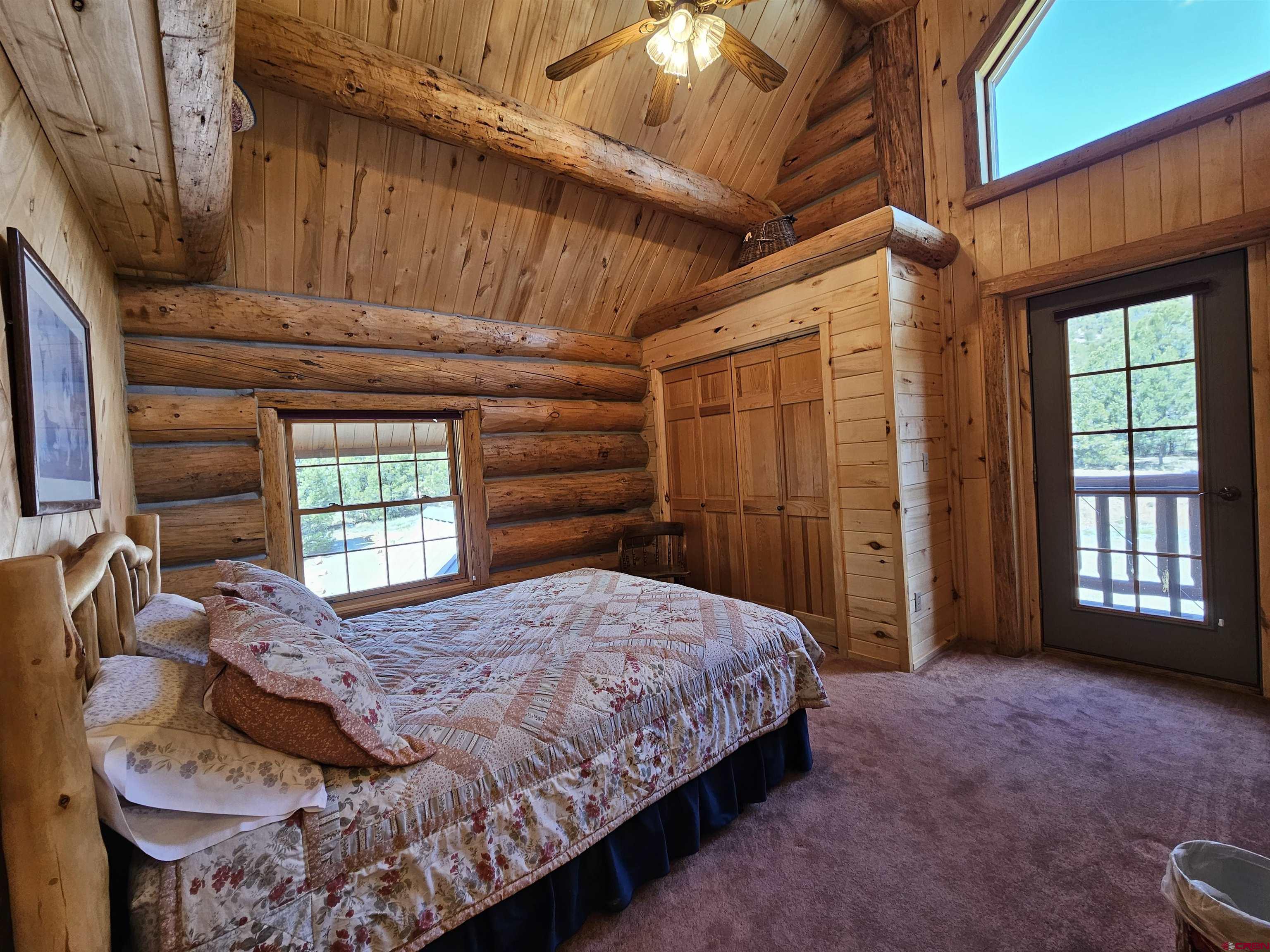212 Pleasant Drive Ridgway, CO 81432 - Photo 21 of 35 a bedroom with a bed dresser and a window