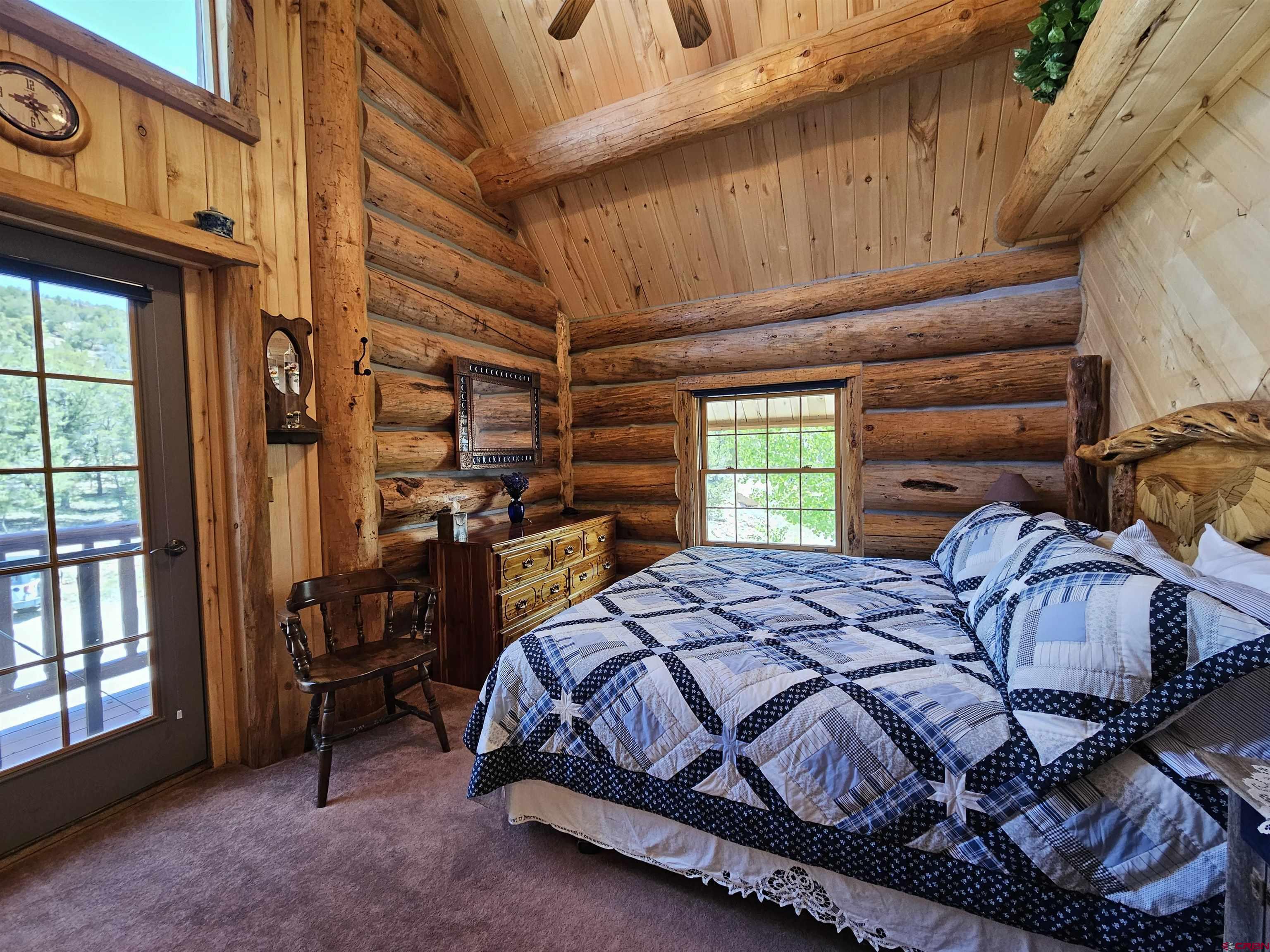 212 Pleasant Drive Ridgway, CO 81432 - Photo 22 of 35 a bed sitting in a bedroom next to a window