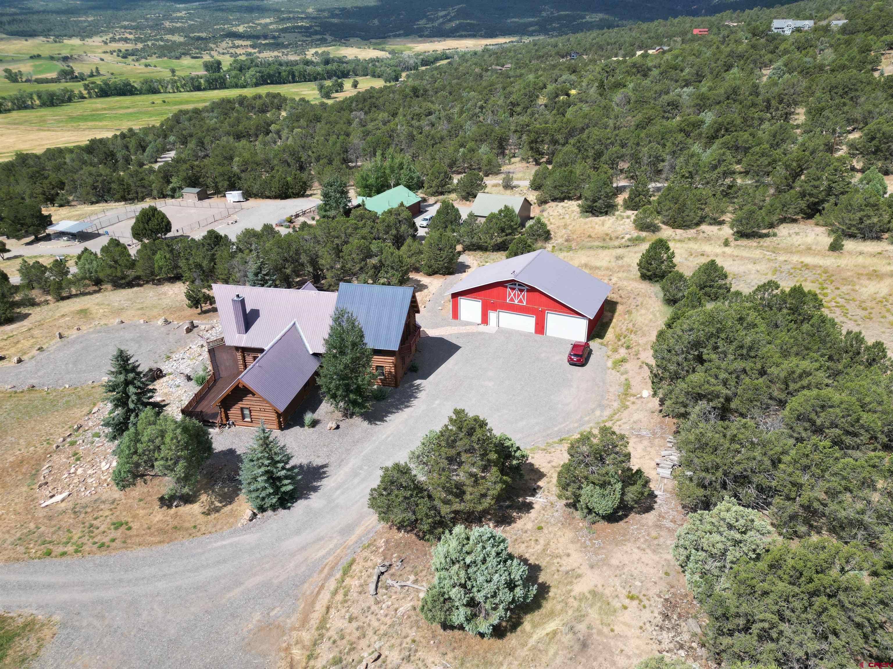 212 Pleasant Drive Ridgway, CO 81432 - Photo 31 of 35 an aerial view of a house with a yard and lake