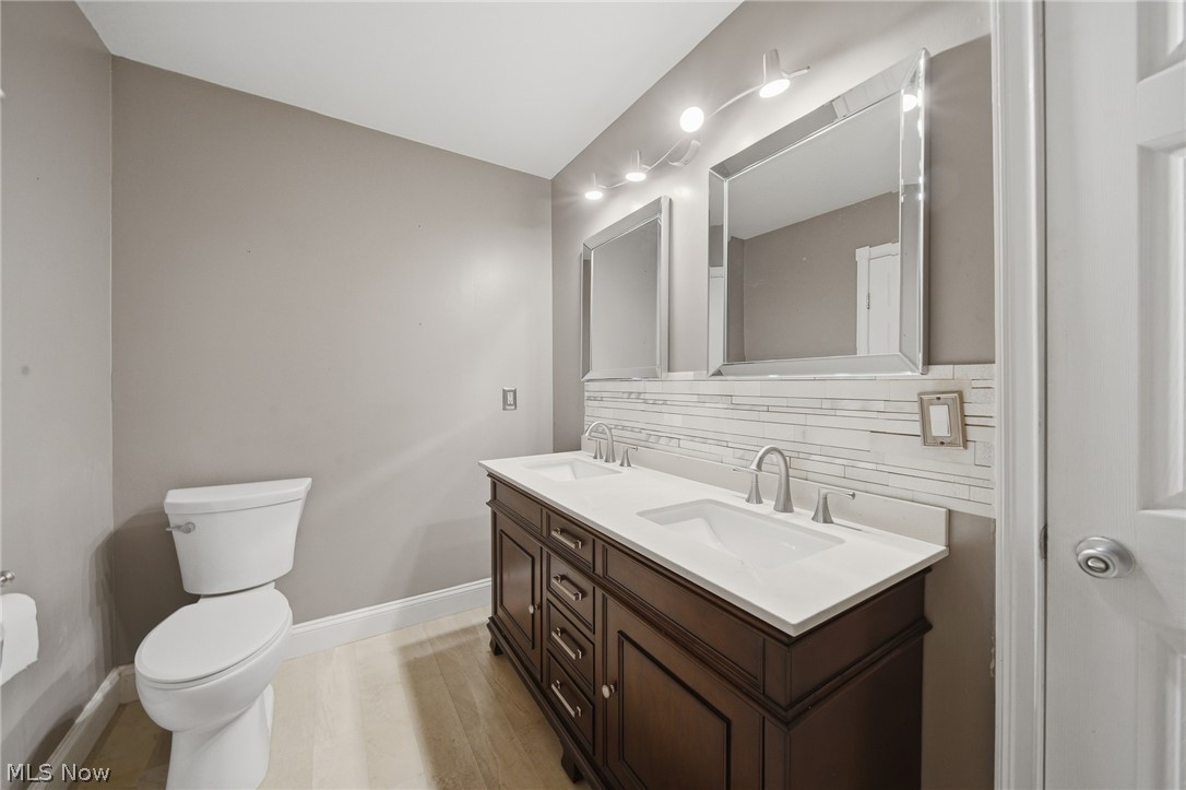 824 South Chillicothe Road, Unit 2 Aurora, OH 44202 - Photo 27 of 42 Bathroom featuring a dual vanity with a dark wood-finish cabinet, white countertops, and two undermount sinks
