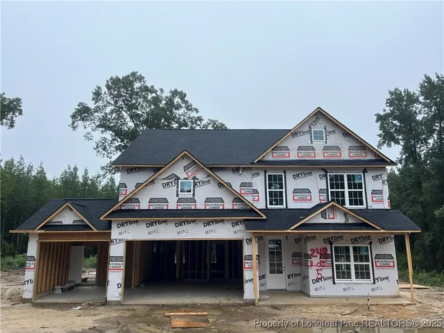 a front view of a house with wooden fence and porch