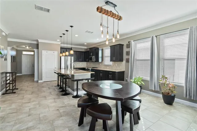 a living room with furniture and a large window with garden view