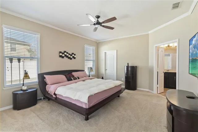 a spacious bedroom with a bed and a large window