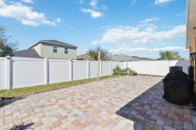 a view of a house with backyard porch and sitting area