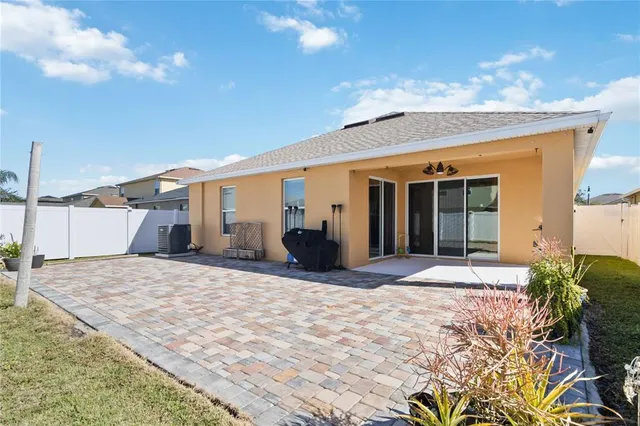 a view of a house with backyard and sitting area