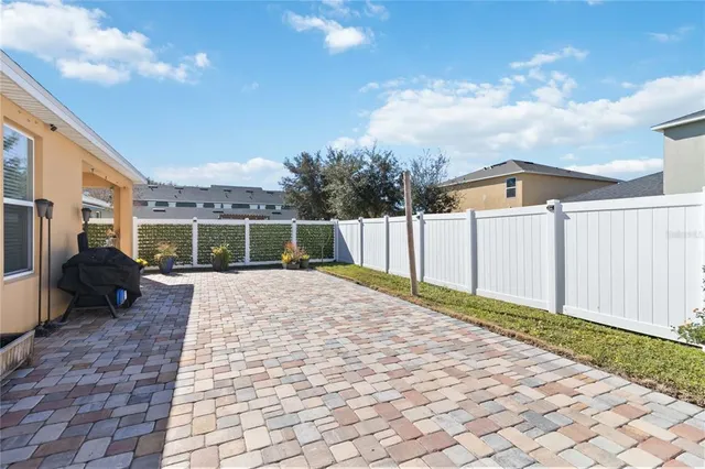 a front view of a house with a yard and tree s