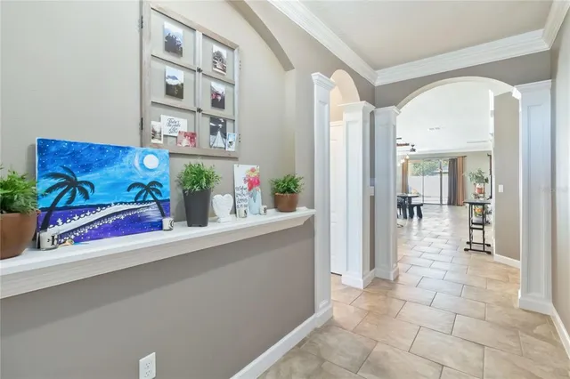 a view of an entryway with a flower pot and table
