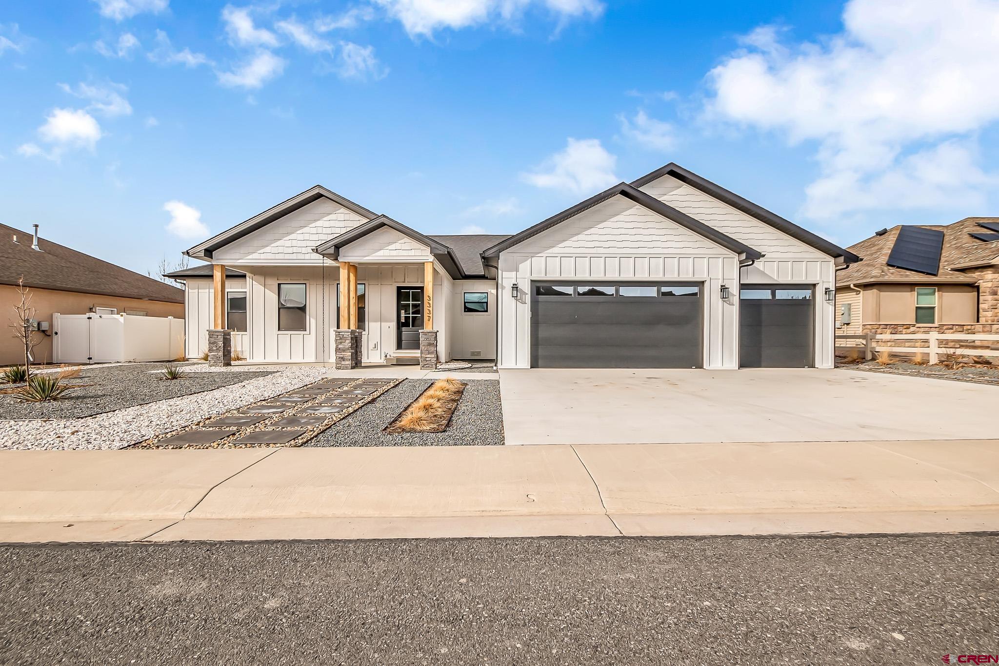 a view of house with yard and large tree in front of it