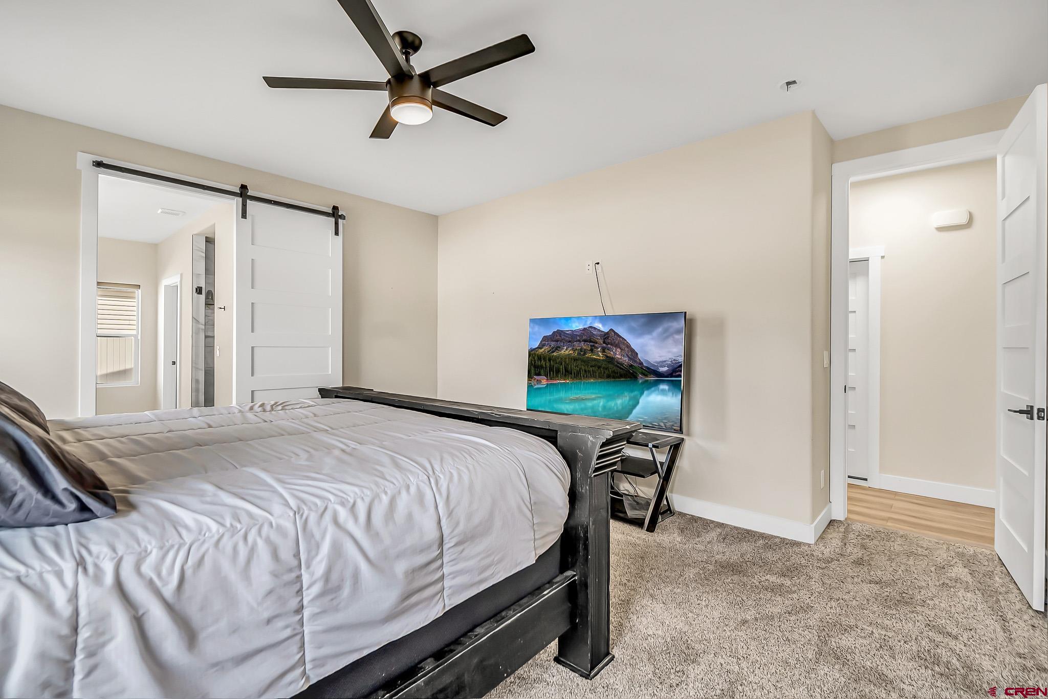 3337 Congress Street Montrose, CO 81401 - Photo 15 of 33 a bedroom with a bed table and chair