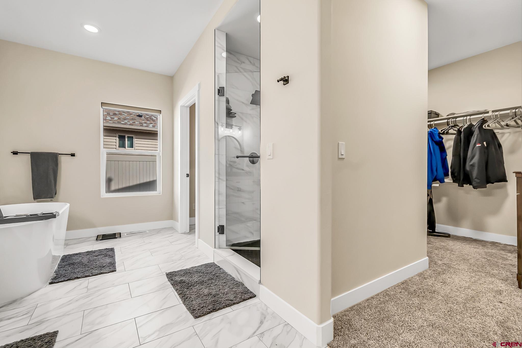 3337 Congress Street Montrose, CO 81401 - Photo 17 of 33 a view of a walk in closet and bedroom