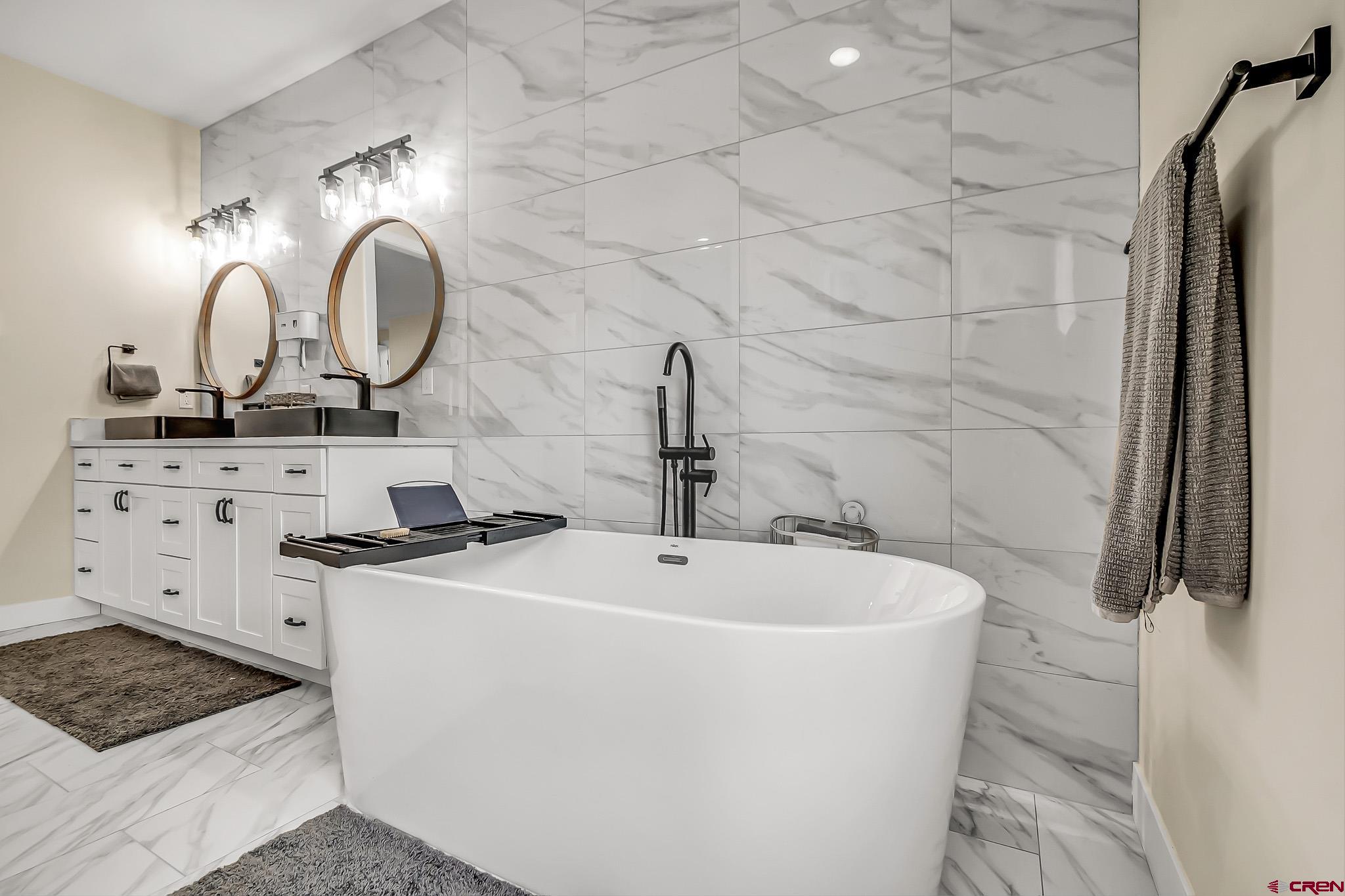3337 Congress Street Montrose, CO 81401 - Photo 18 of 33 a bathroom with a sink a toilet and a mirror