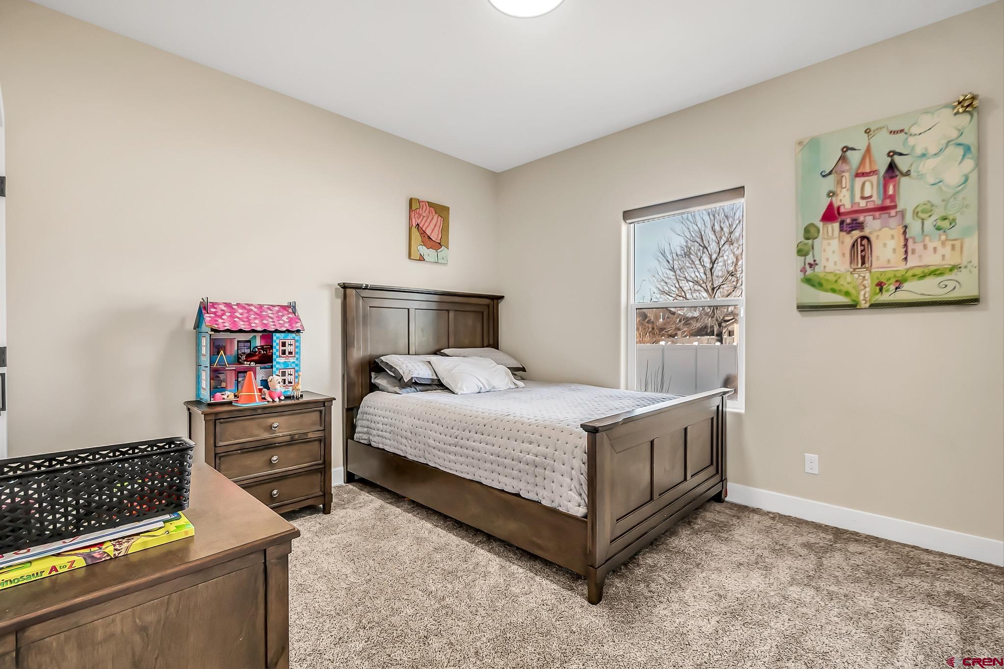 3337 Congress Street Montrose, CO 81401 - Photo 19 of 33 a bedroom with a bed and dresser