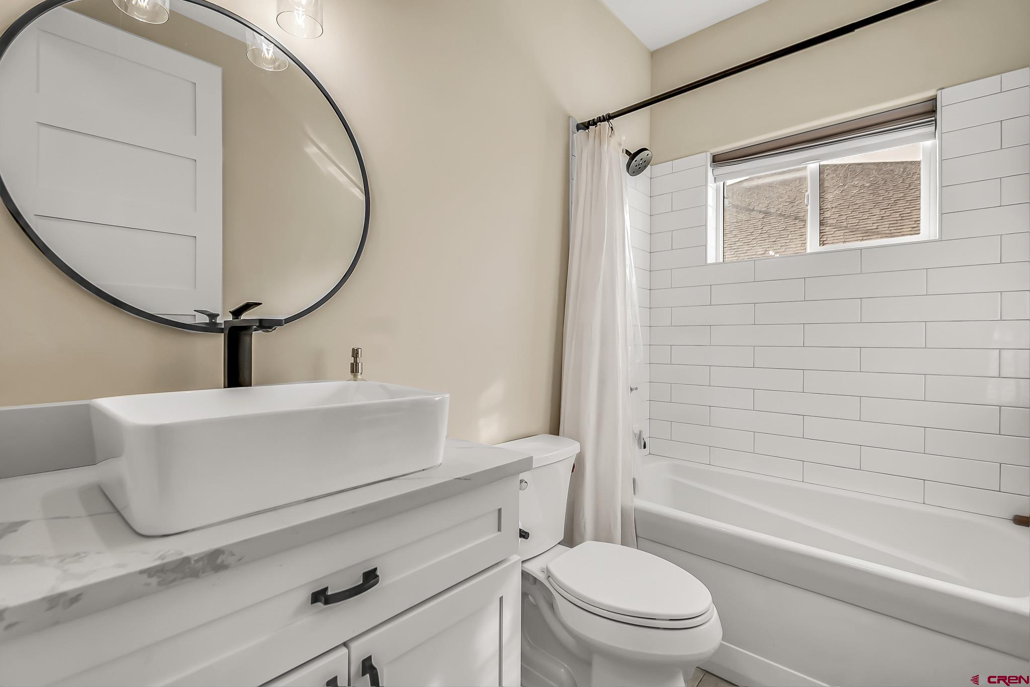 3337 Congress Street Montrose, CO 81401 - Photo 22 of 33 a bathroom with a sink a toilet and a mirror