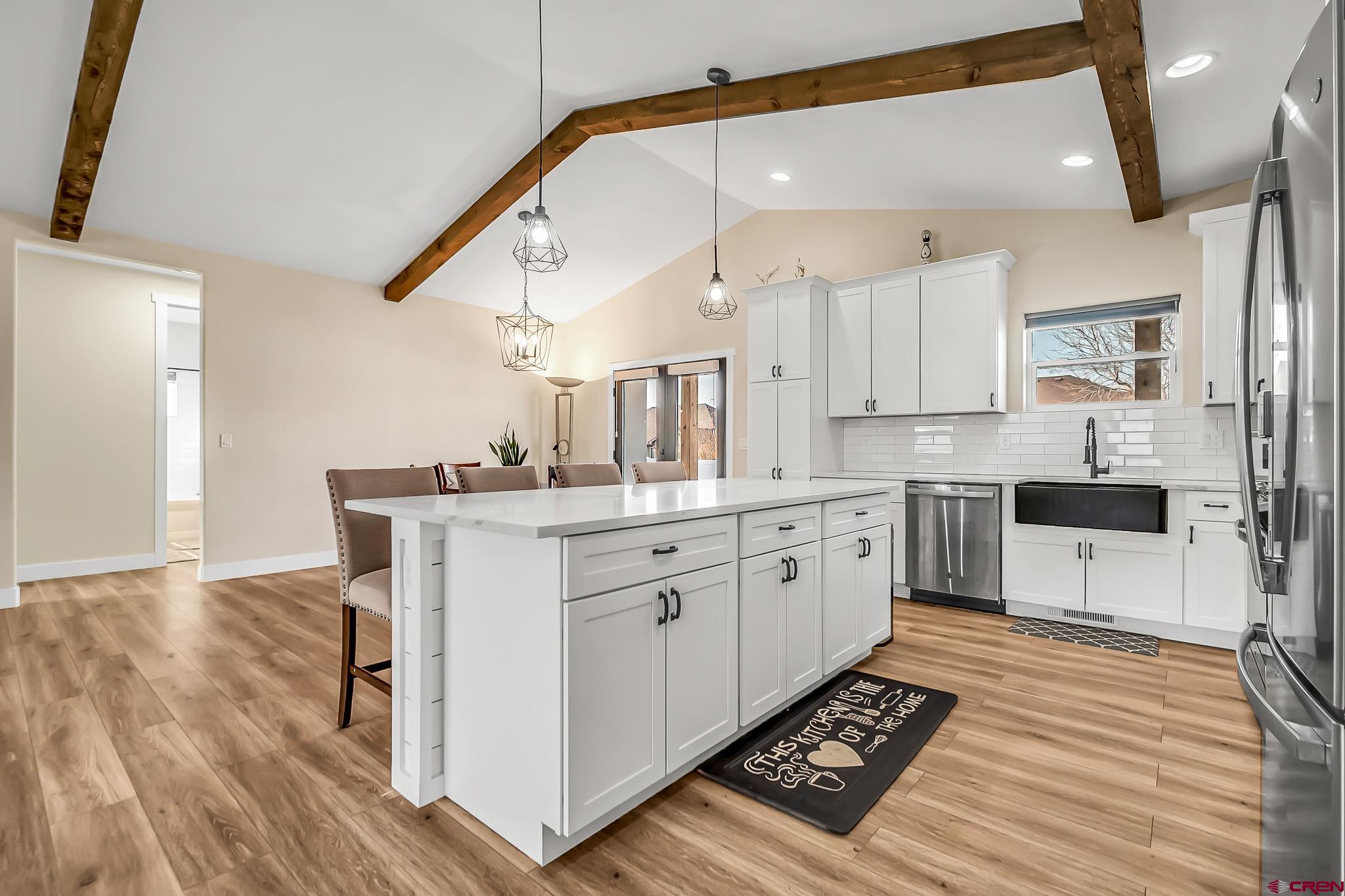 3337 Congress Street Montrose, CO 81401 - Photo 8 of 33 a kitchen with a sink cabinets and wooden floor