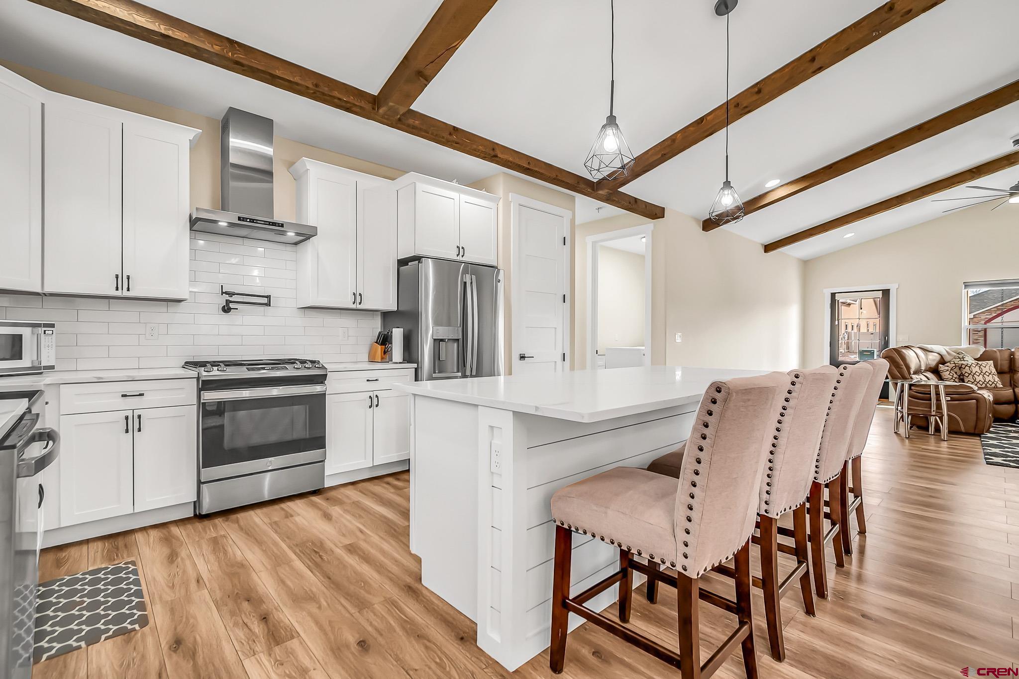 3337 Congress Street Montrose, CO 81401 - Photo 10 of 33 a kitchen with stainless steel appliances granite countertop a stove refrigerator dining table and chairs