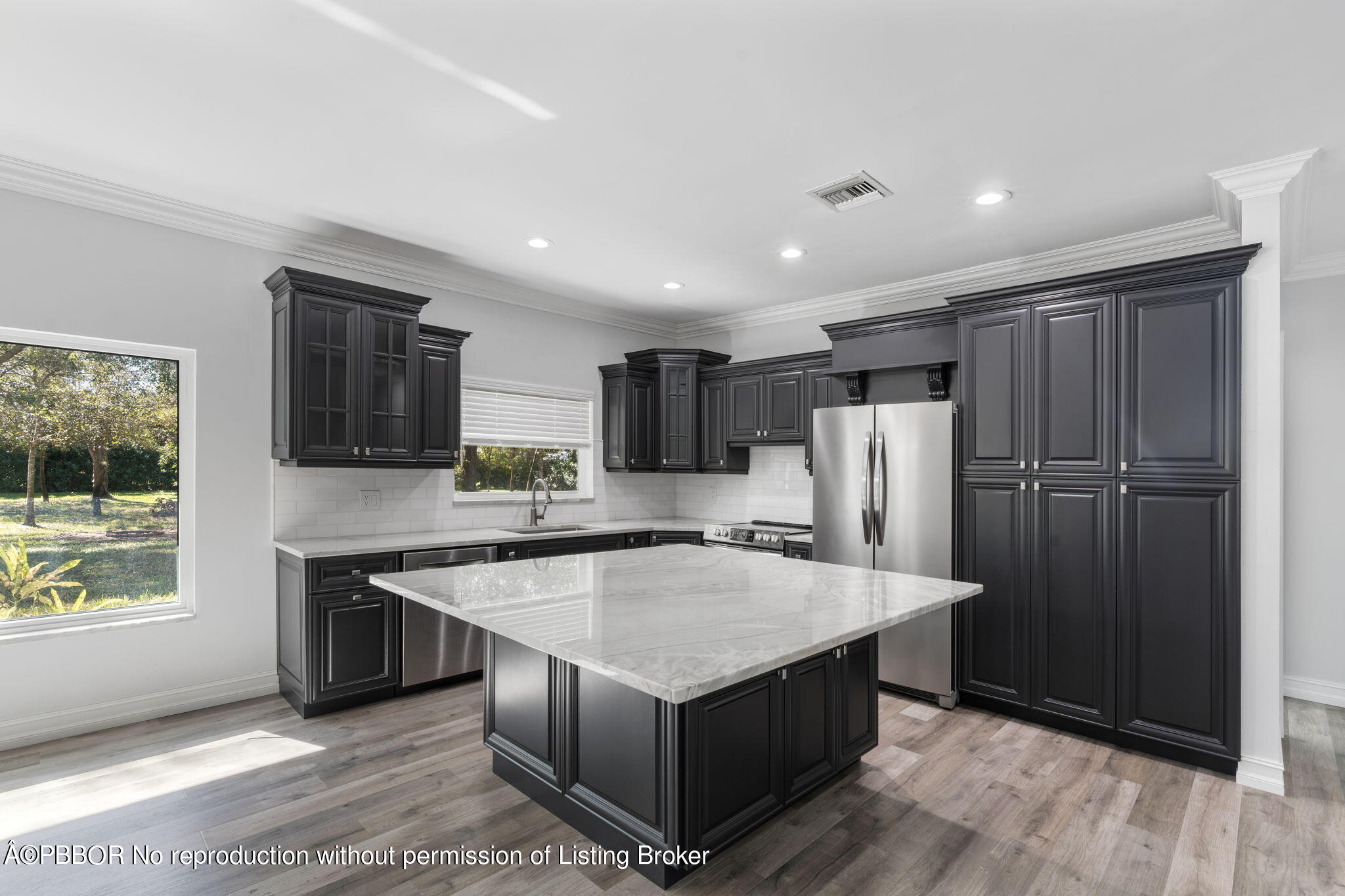 5608 Old Fort Jupiter Road Jupiter, FL 33458 - Photo 11 of 59 a kitchen with stainless steel appliances granite countertop a refrigerator a sink and a stove