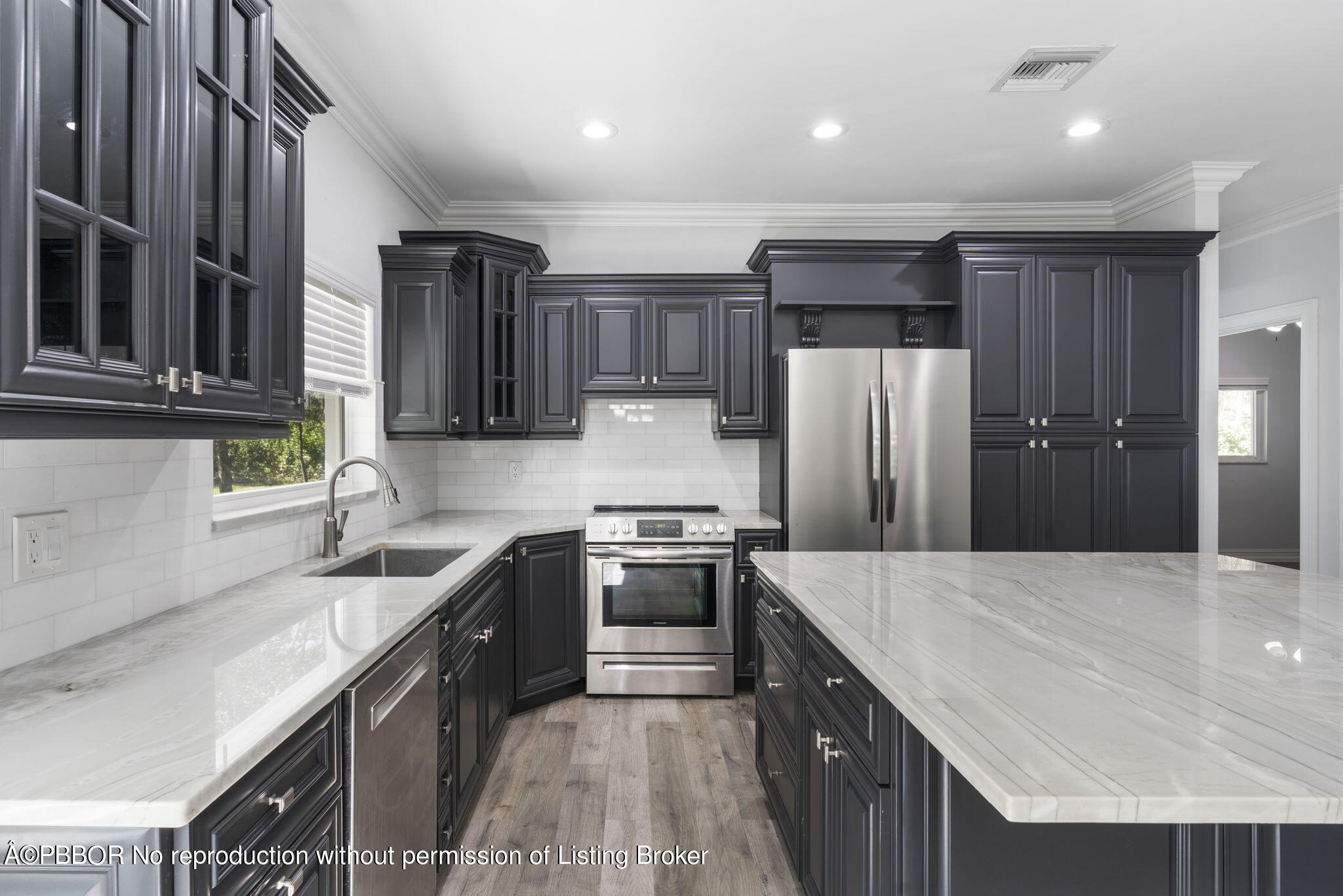 5608 Old Fort Jupiter Road Jupiter, FL 33458 - Photo 13 of 59 a kitchen with stainless steel appliances granite countertop a sink stove and refrigerator