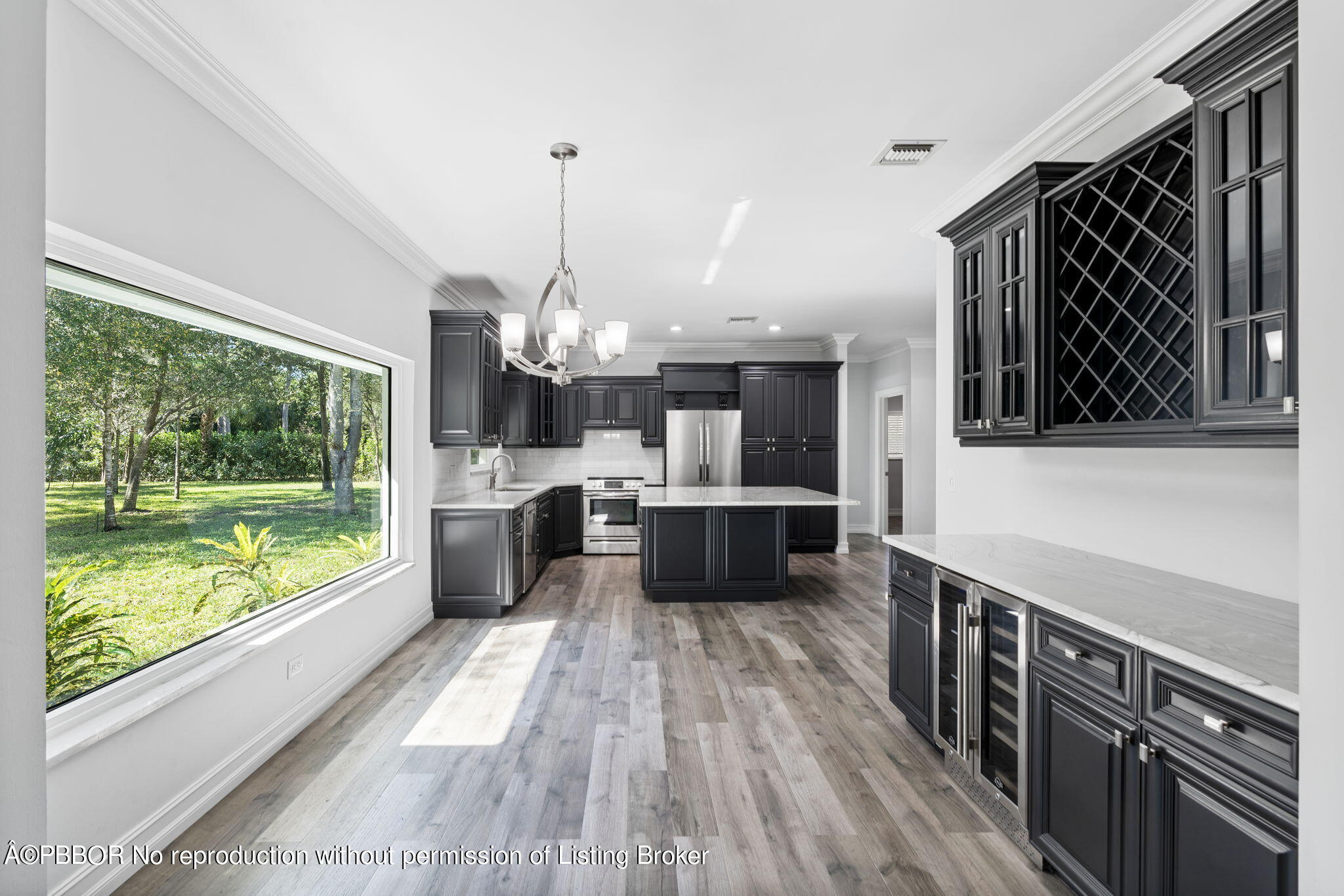 5608 Old Fort Jupiter Road Jupiter, FL 33458 - Photo 15 of 59 a kitchen with stainless steel appliances a sink a counter top space cabinets and wooden floor