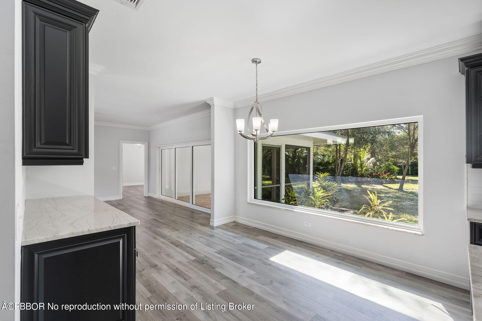 5608 Old Fort Jupiter Road Jupiter, FL 33458 - Photo 17 of 59 a view of an empty room with wooden floor and a window