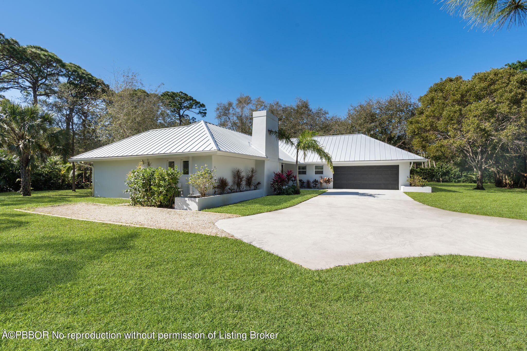 5608 Old Fort Jupiter Road Jupiter, FL 33458 - Photo 2 of 59 a front view of a house with yard and green space