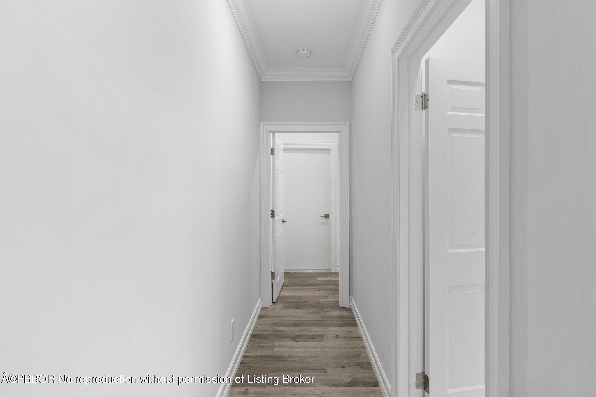 5608 Old Fort Jupiter Road Jupiter, FL 33458 - Photo 25 of 59 a view of a hallway with wooden floor and a bathroom