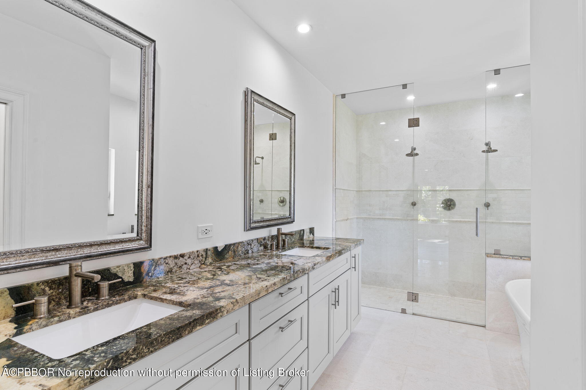 5608 Old Fort Jupiter Road Jupiter, FL 33458 - Photo 28 of 59 a bathroom with a granite countertop double vanity sink a mirror and a bathtub