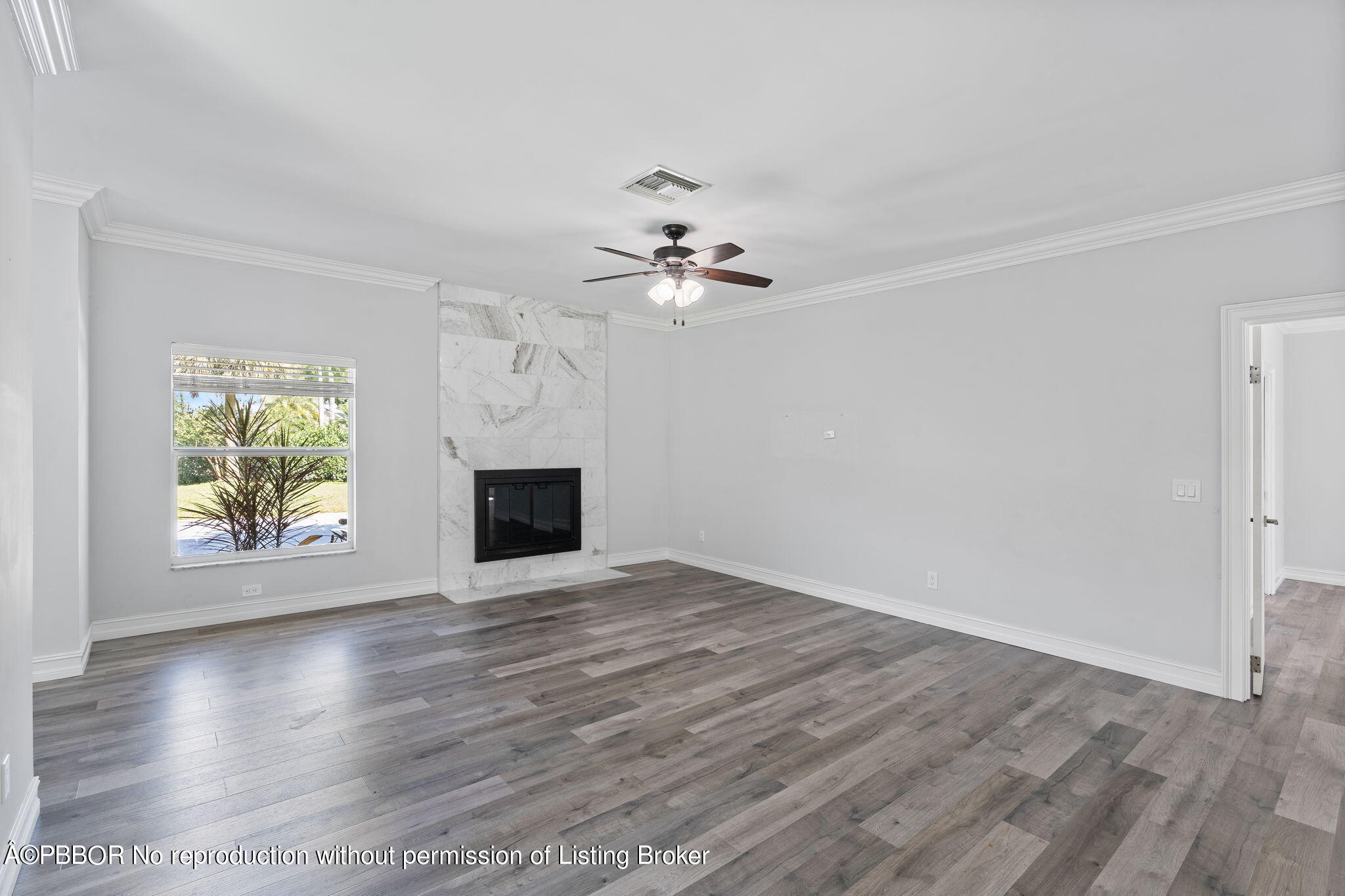 5608 Old Fort Jupiter Road Jupiter, FL 33458 - Photo 5 of 59 an empty room with windows and fireplace