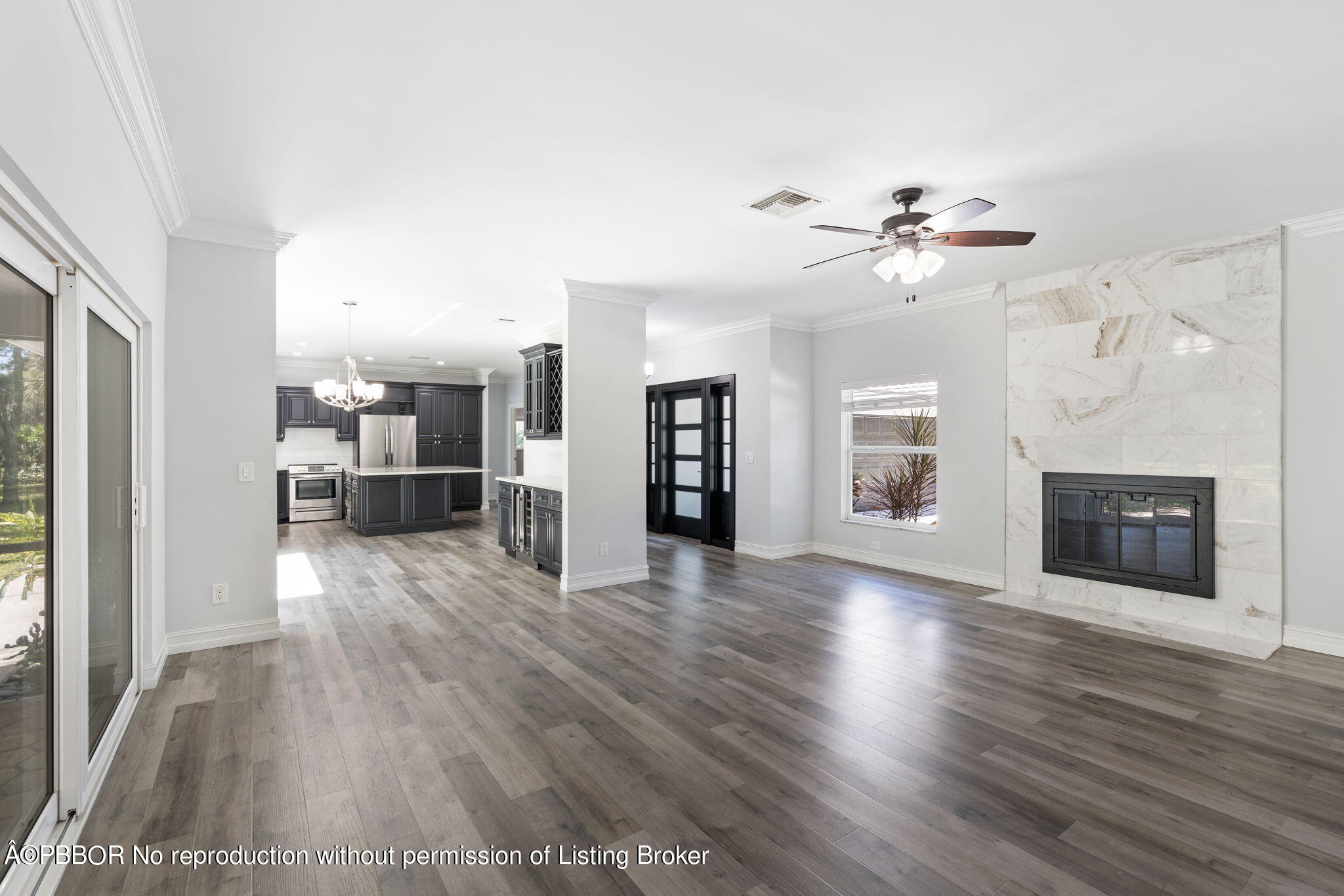 5608 Old Fort Jupiter Road Jupiter, FL 33458 - Photo 10 of 59 a view of a livingroom with a fireplace a ceiling fan and wooden floor