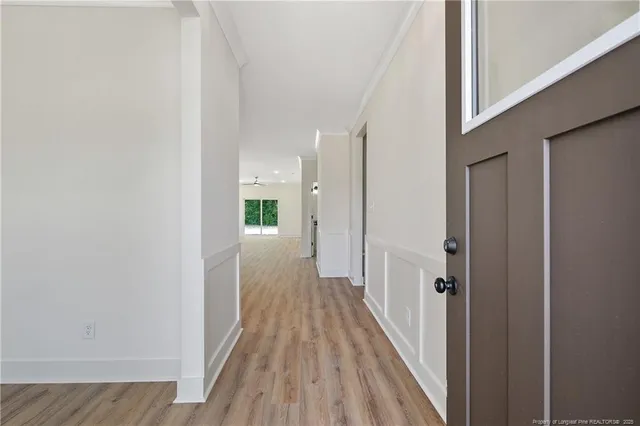a view of a hallway with wooden floor and staircase