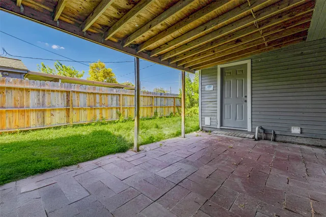 a view of a backyard of a house with a garden and plants