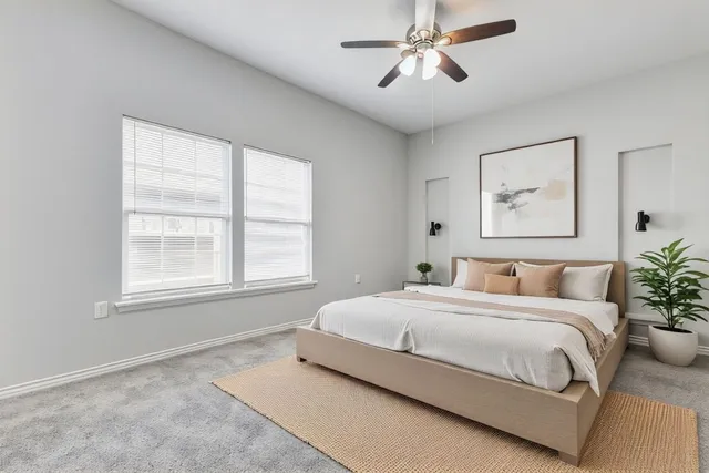 a bedroom with a large bed and a chandelier