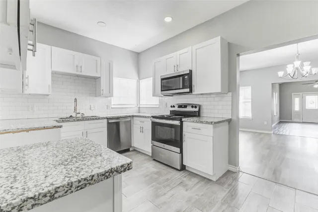 a kitchen with a sink stove and microwave