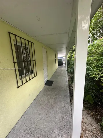 a livingroom with workspace and a couch