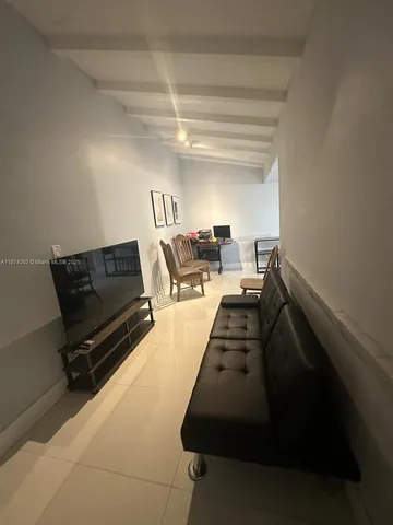 a kitchen with a sink a refrigerator and cabinets