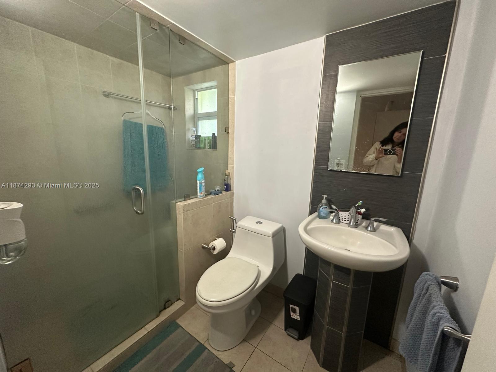 324 Southwest 23rd Avenue, Unit 2 Miami, FL 33135 - Photo 8 of 8 a bathroom with a toilet sink and mirror