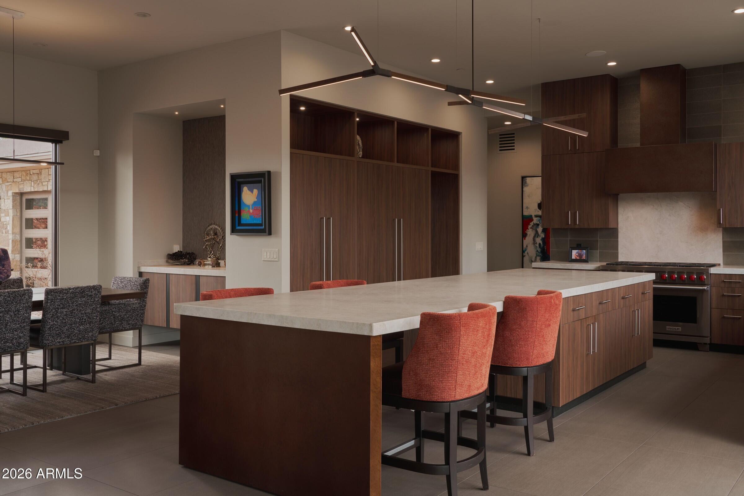 2925 Red Hawk Lane Sedona, AZ 86336 - Photo 11 of 35 a dining hall with stainless steel appliances kitchen island granite countertop a dining table chairs and a refrigerator