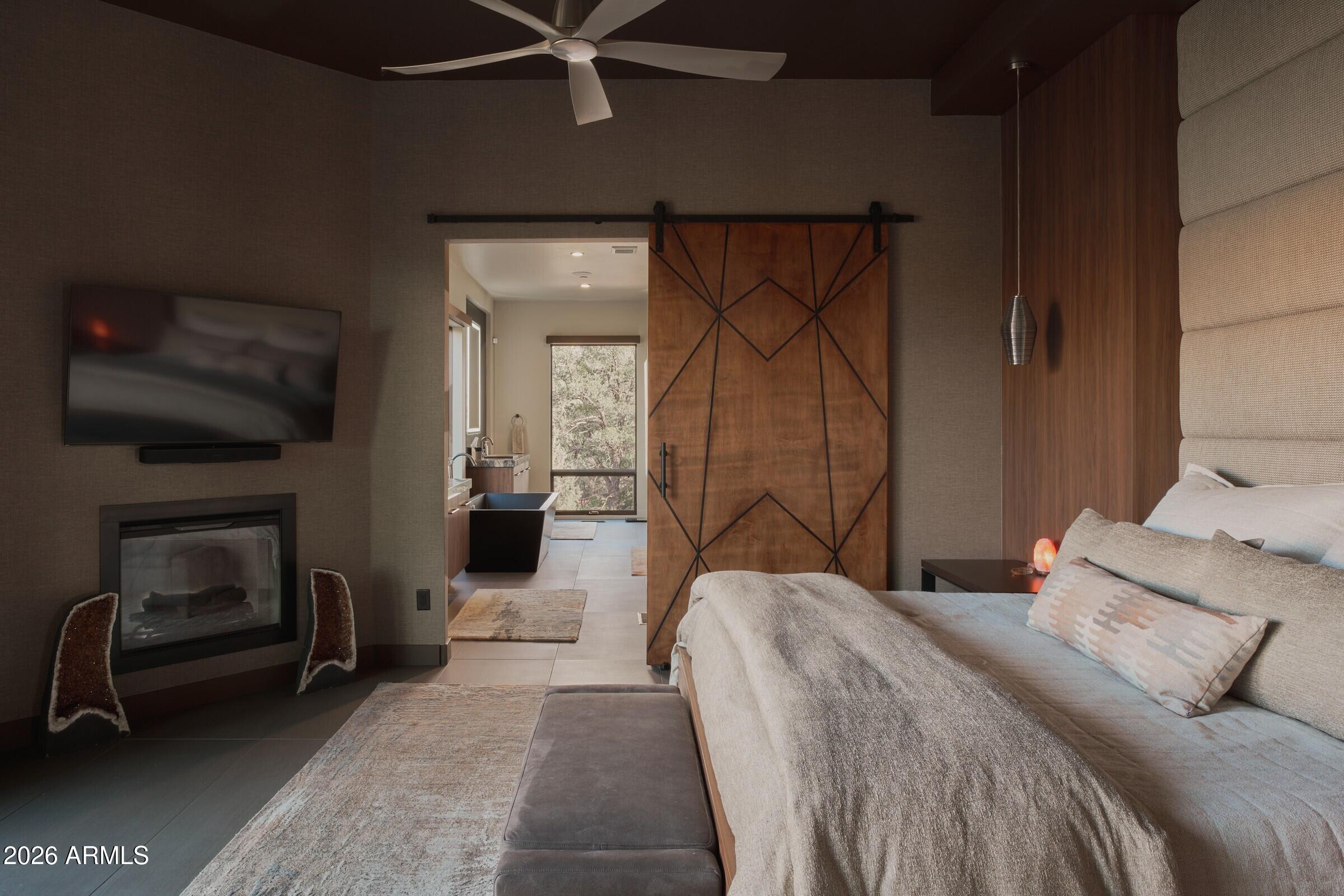 2925 Red Hawk Lane Sedona, AZ 86336 - Photo 17 of 35 a bedroom with a bed and a fireplace