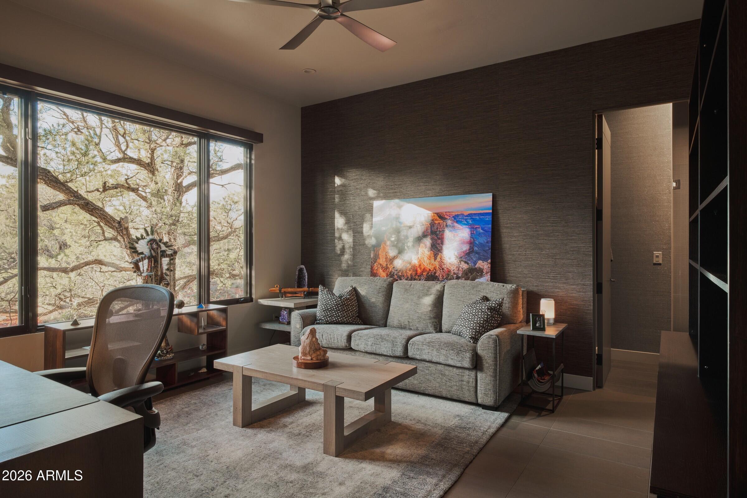 2925 Red Hawk Lane Sedona, AZ 86336 - Photo 25 of 35 a living room with furniture and a floor to ceiling window