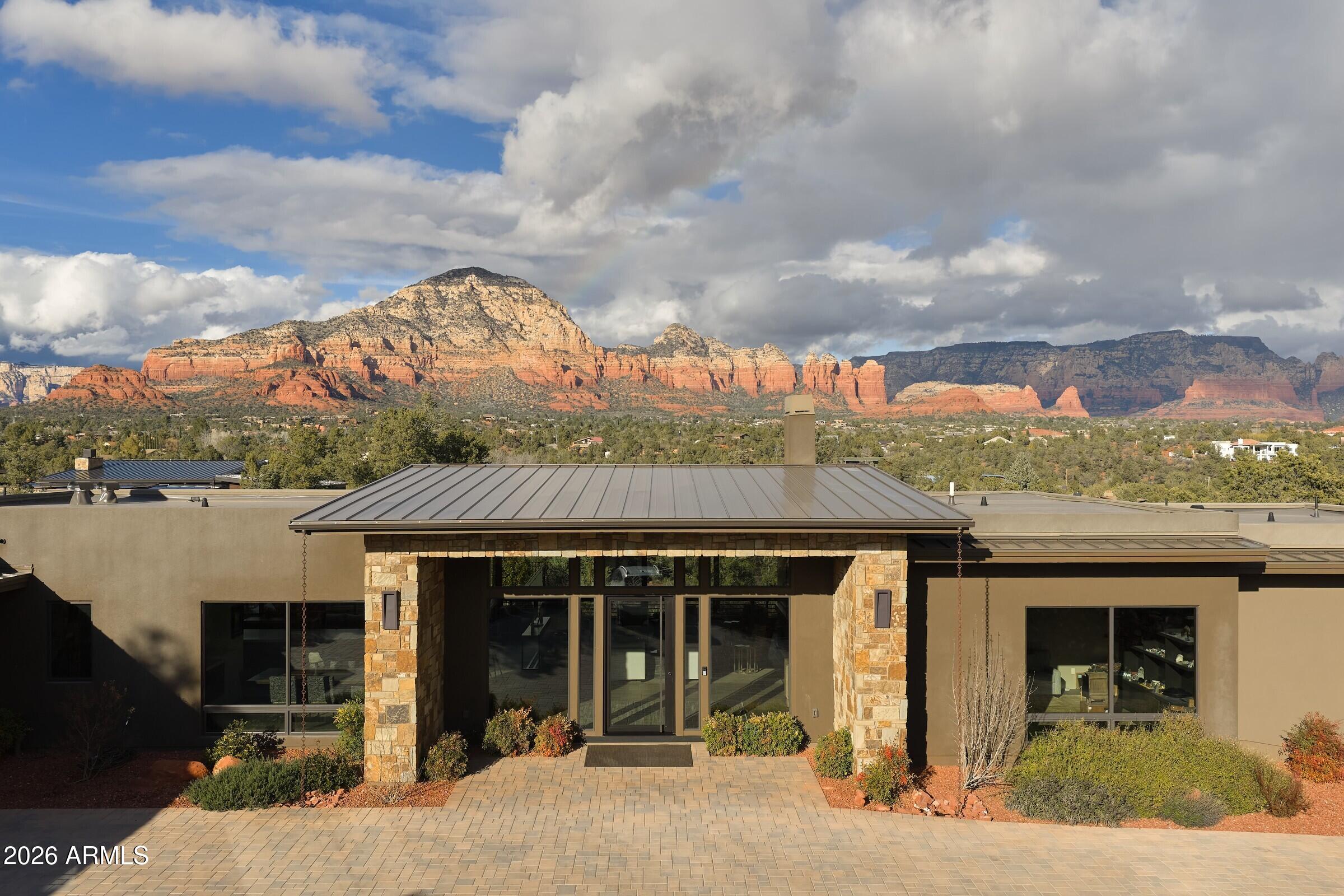 2925 Red Hawk Lane Sedona, AZ 86336 - Photo 31 of 35 a front view of a house with a garden and balcony